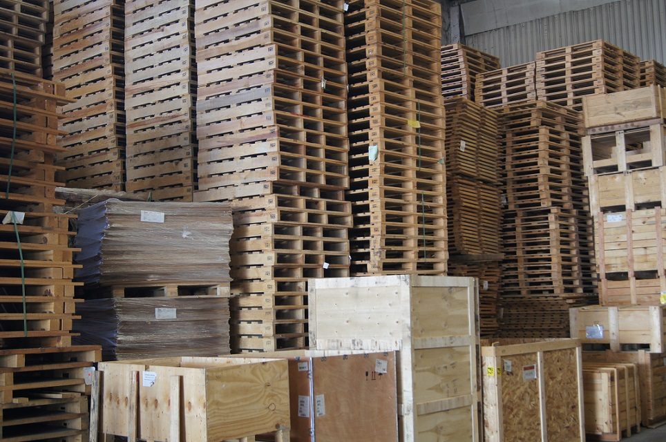 Embalaje de madera apilado en un almacén. Cajas de embalaje listas para transporte o almacenamiento.